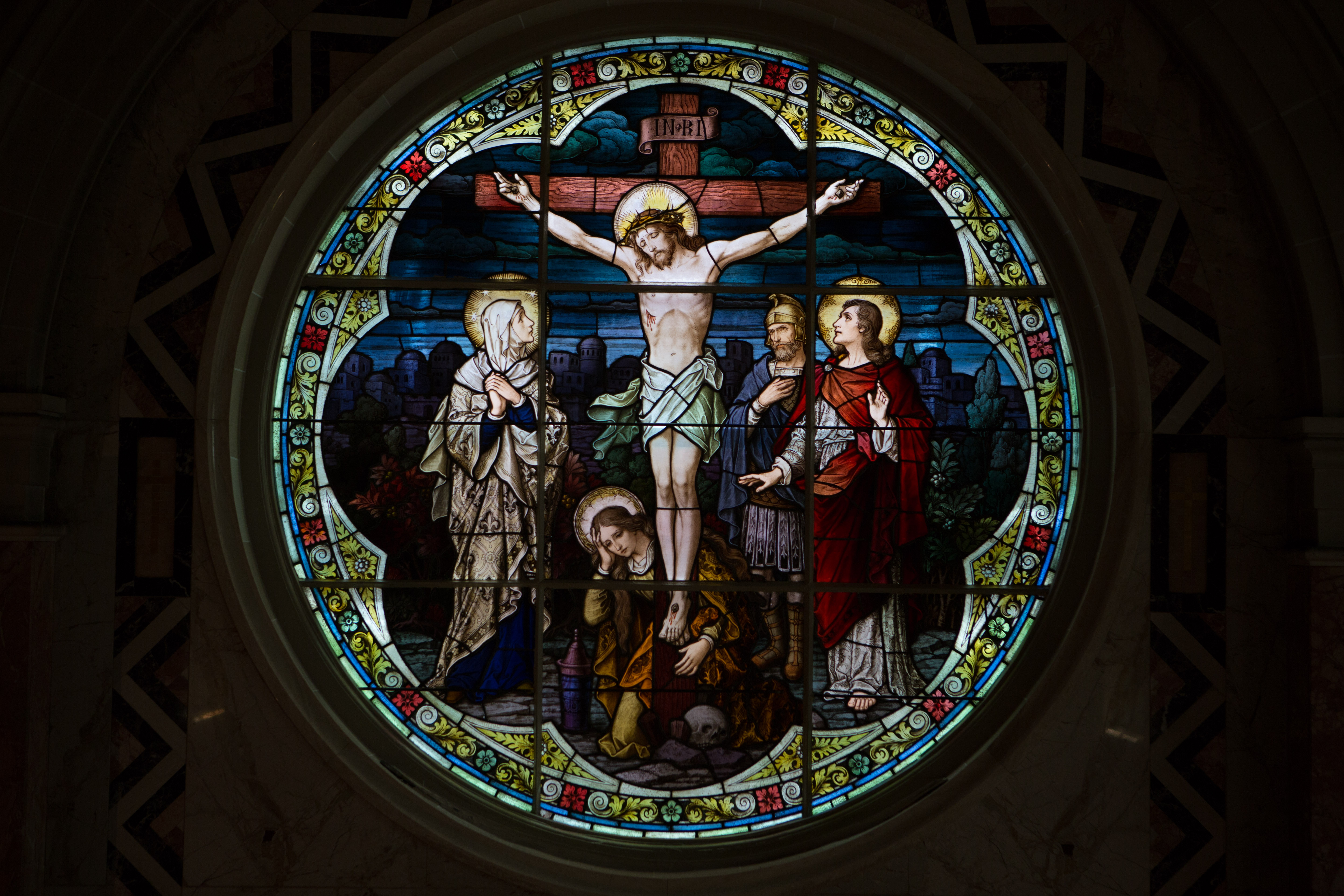 An image of a stained glass window depicting the crucifixion