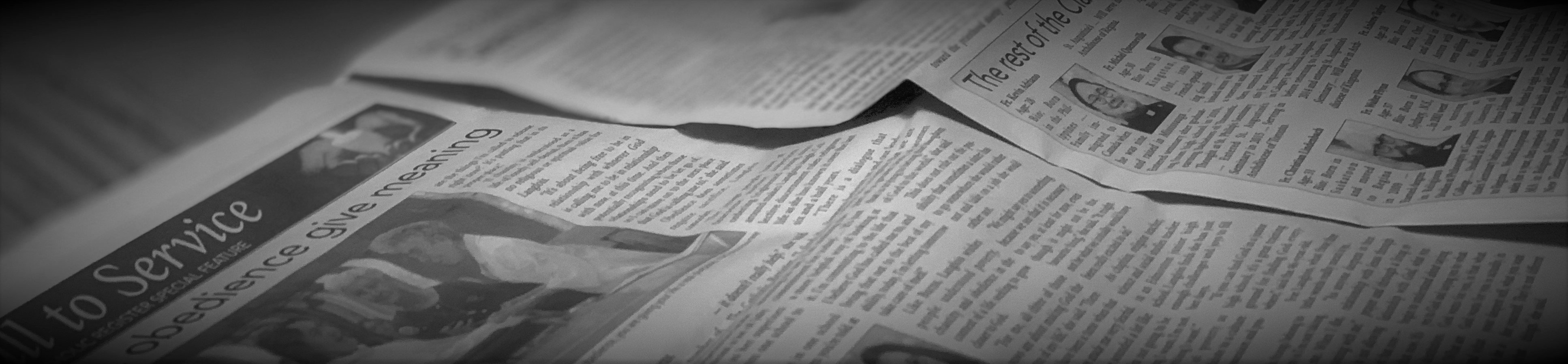 A black and white image of an open newspaper
