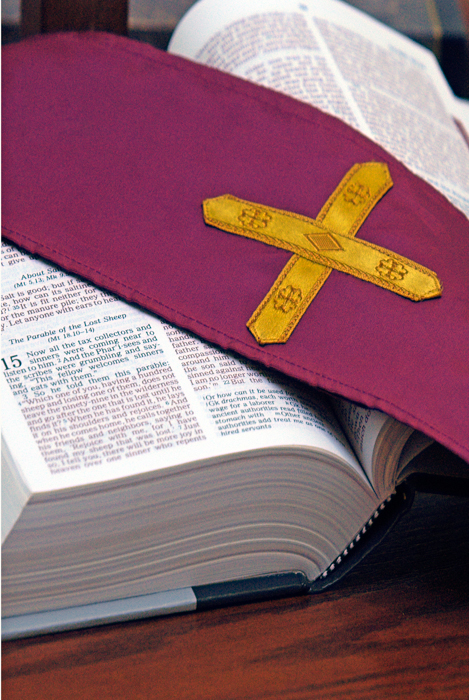 A picture of a Purple Stole on top of an open bible. The colour purple signifies Lent, penance, sorrow and conversion.