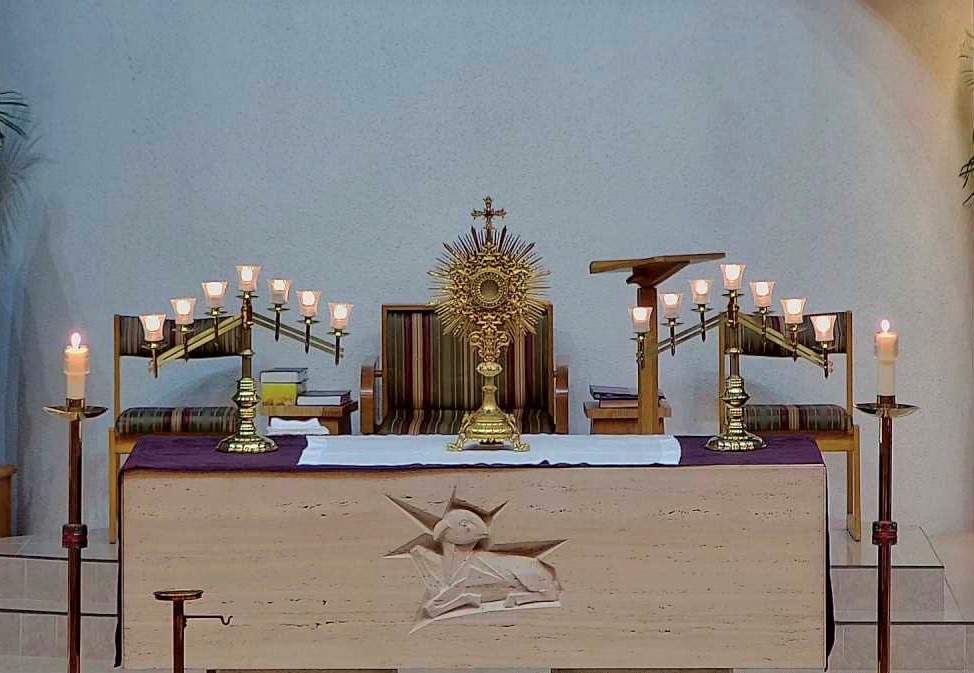 A picture of the golden Monstrance with the consecrated Host on the altar at St. John's